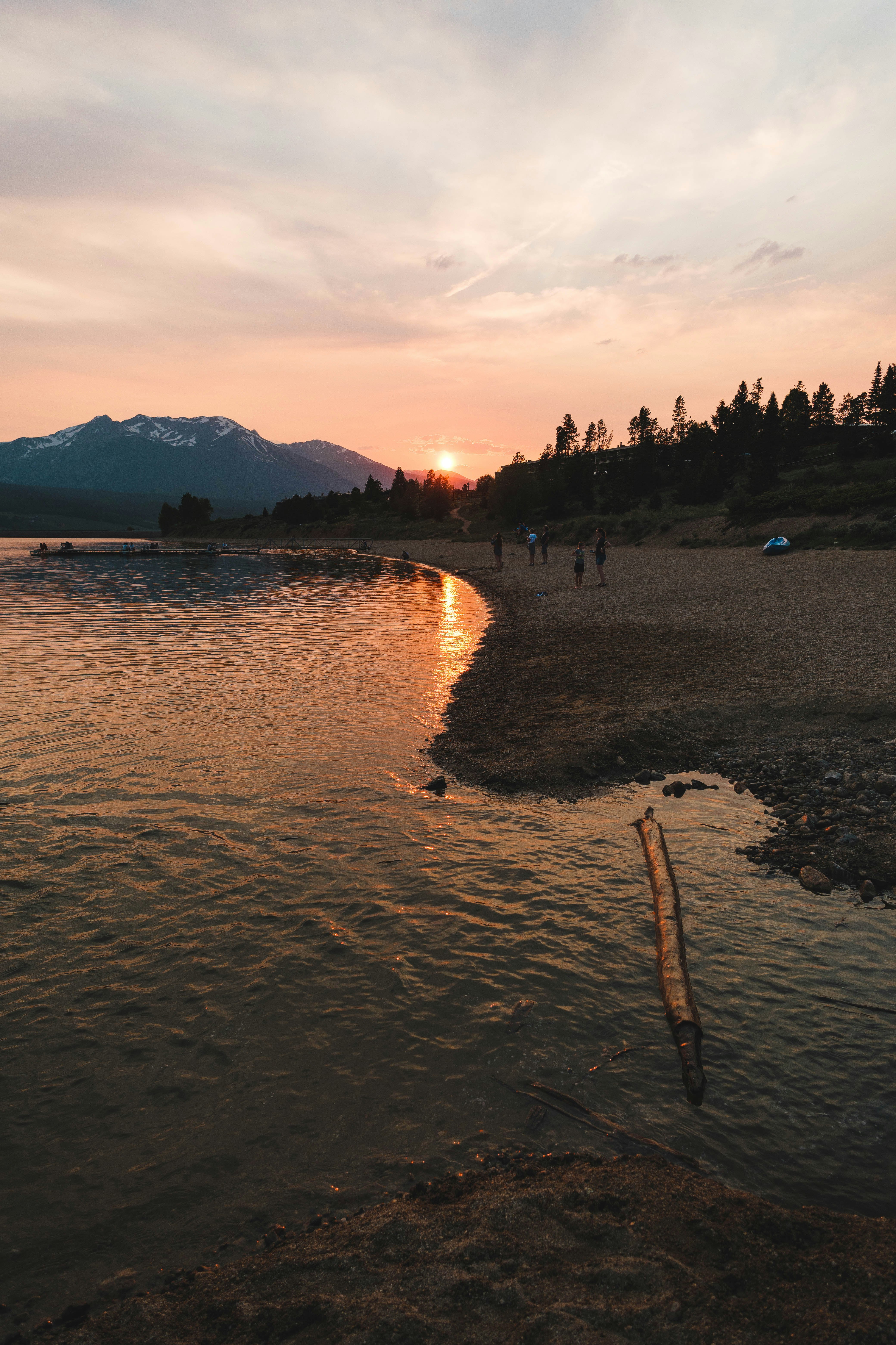 people on beach during sunset